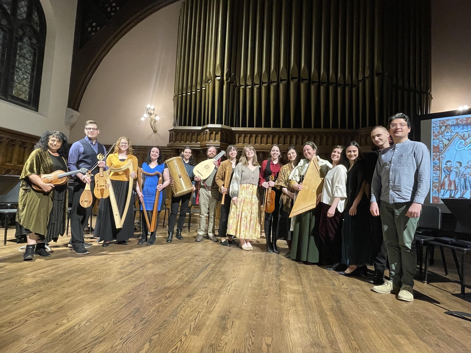 The full Collegium Musicum ensemble standing together on stage after the Cantigas! concert