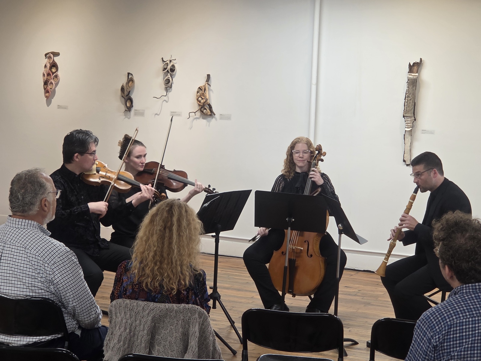 Wit's Folly, a quintet of historical strings and clarinet, performing for a small audience in a gallery