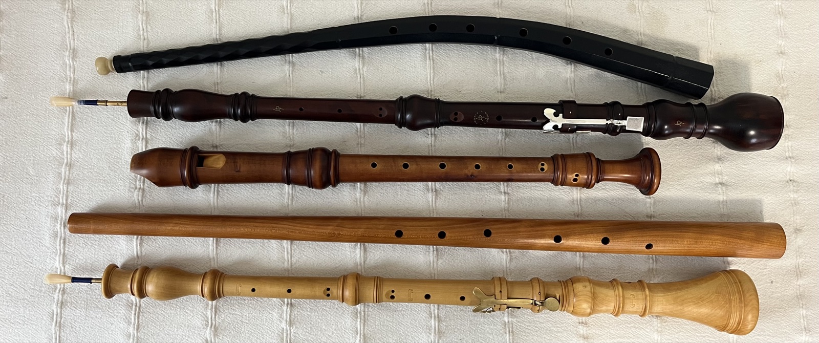 Five historical wind instruments laid side by side